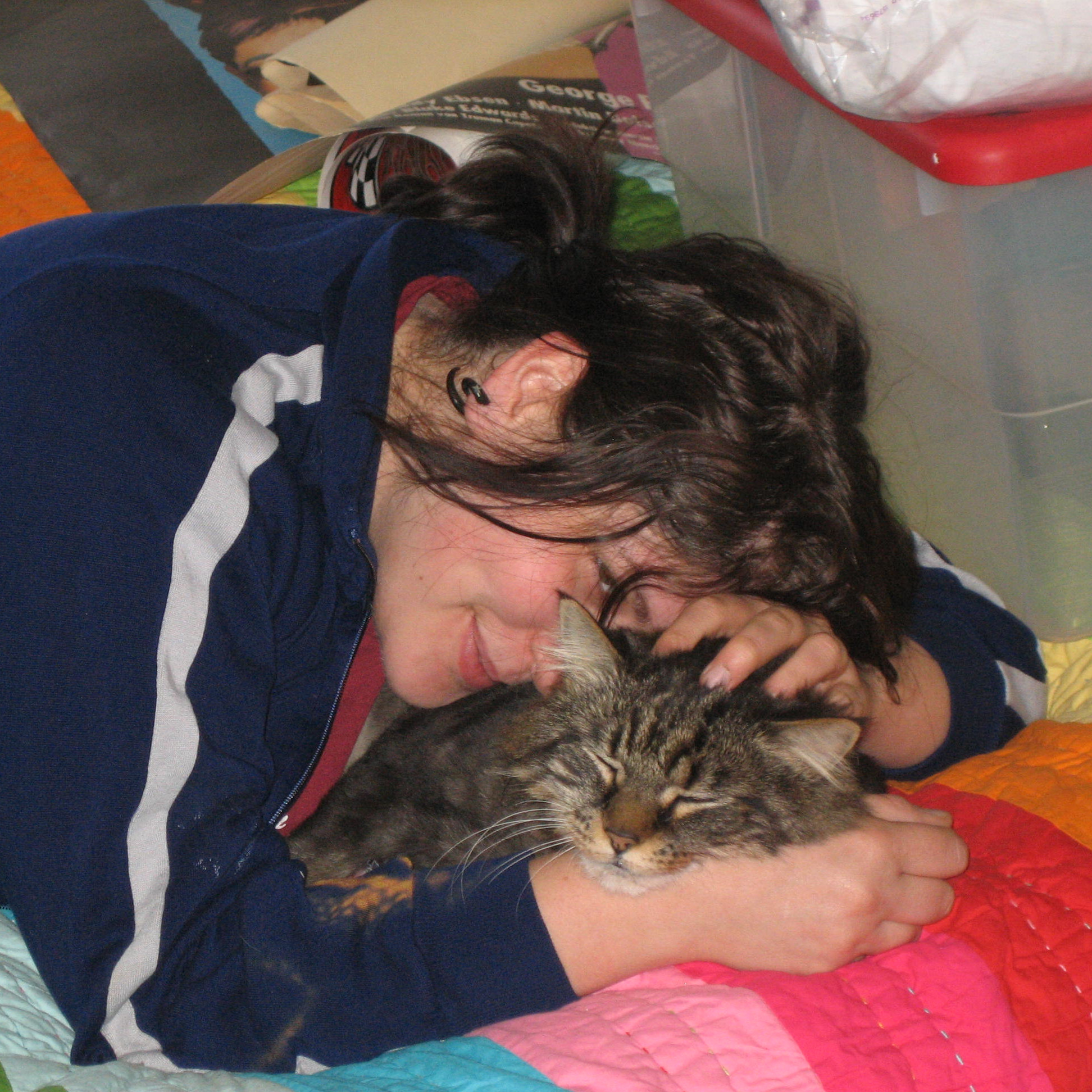 a woman cuddling a sleeping cat
